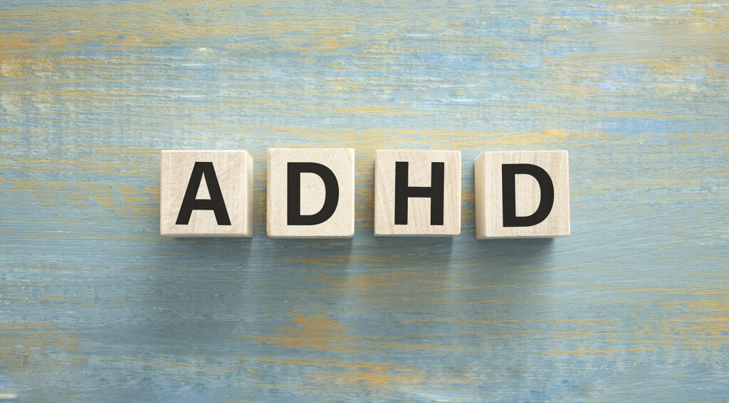 "ADHD" on wooden cubes. ADHD treatment for adults in Charlotte, NC can help you with decision making & fatigue. Reach out today for help!