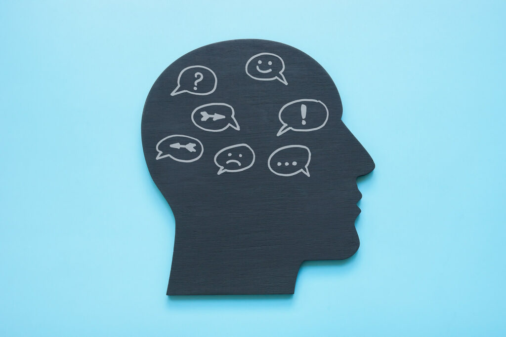 A cartoon of an outline of a head with different speech bubbles in the brain. Representing how you can use dialectical behavior therapy in Charlotte, NC can help you emotional regulation. Call us today to start practicing radical acceptance. 