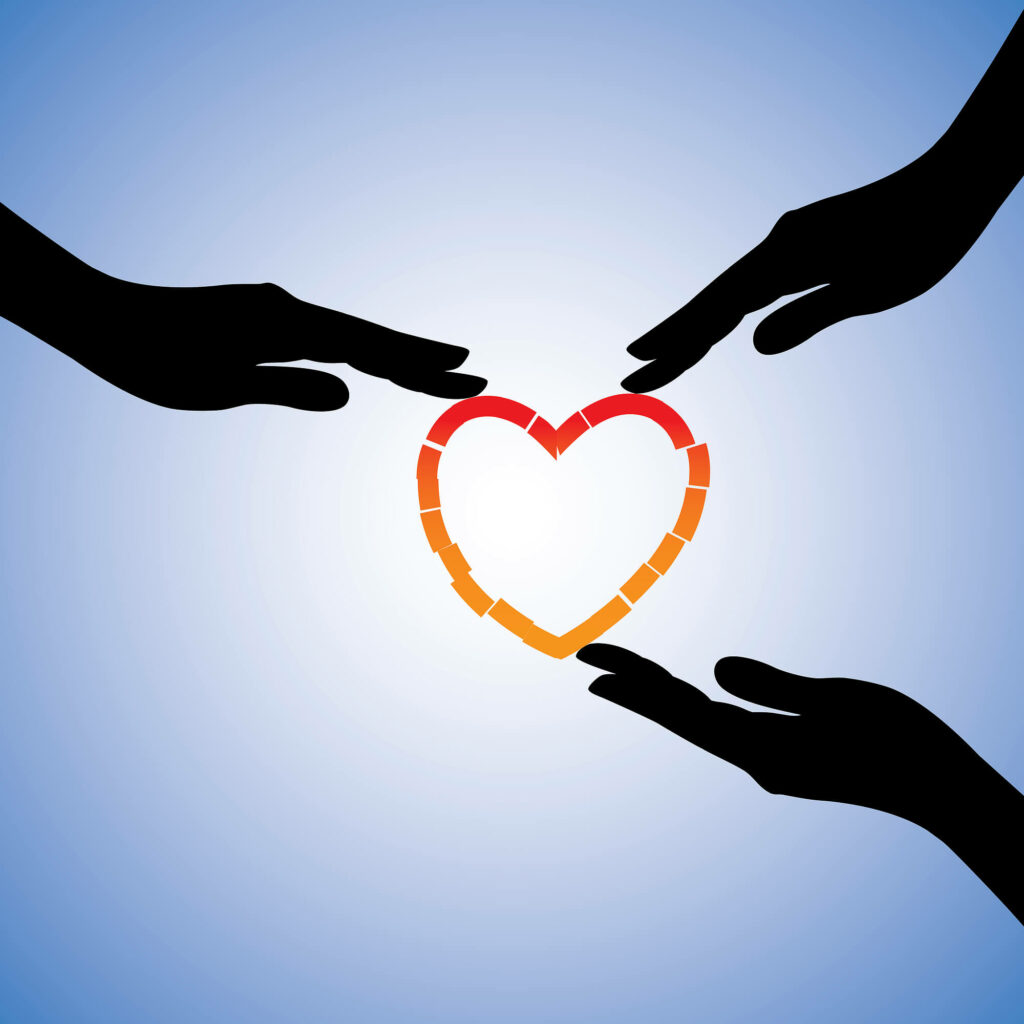 Three hands holding together a broken heart. If you see yourself having a trauma bond, reach out to us today. We offer trauma treatment in Charlotte, NC to support individuals like you.